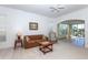 Bright living room featuring neutral carpet and a view of the screened patio at 835 Chalmers Dr # 835, Venice, FL 34293