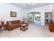 Inviting living room with neutral carpet and view to the screened patio at 835 Chalmers Dr # 835, Venice, FL 34293