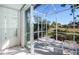 Inviting screened patio with white seating and serene views of the natural landscape at 835 Chalmers Dr # 835, Venice, FL 34293