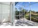 Screened patio offering tranquil outdoor living with views of lush greenery and blue skies at 835 Chalmers Dr # 835, Venice, FL 34293