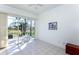 Tile sunroom with large glass doors opening to scenic backyard views and outdoor seating at 835 Chalmers Dr # 835, Venice, FL 34293