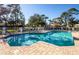 Community swimming pool with brick trim and lounge chairs provides residents a serene outdoor space at 835 Chalmers Dr # 835, Venice, FL 34293