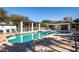 Community swimming pool features clear blue water, poolside seating, and shade structure at 835 Chalmers Dr # 835, Venice, FL 34293