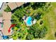 Aerial view of a community pool surrounded by lush landscaping and residential buildings at 838 Bird Bay Way # 114, Venice, FL 34285