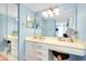 Well-lit bathroom featuring a vanity with a large mirror, seating, and ample storage at 838 Bird Bay Way # 114, Venice, FL 34285
