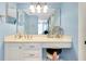 Well-lit bathroom featuring a vanity with a large mirror, seating, and ample storage at 838 Bird Bay Way # 114, Venice, FL 34285