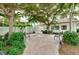 Charming courtyard area with a fountain, benches, lush greenery, and tranquil ambiance at 838 Bird Bay Way # 114, Venice, FL 34285