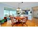 Dining room with hardwood floors and view of the sunroom at 838 Bird Bay Way # 114, Venice, FL 34285