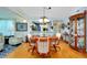 Dining room with hardwood floors, chandelier, and access to kitchen and living room at 838 Bird Bay Way # 114, Venice, FL 34285