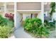 Inviting walkway up to a condo entrance, surrounded by beautiful and lush landscaping at 838 Bird Bay Way # 114, Venice, FL 34285