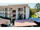 Condominium building with multiple floors, balconies, covered parking, and lush landscaping at 838 Bird Bay Way # 114, Venice, FL 34285