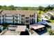 Exterior view showcasing the building with covered parking, landscaping, and balcony access at 838 Bird Bay Way # 114, Venice, FL 34285