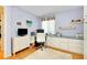 Inviting home office features custom built-ins, a large window, and comfortable office chair at 838 Bird Bay Way # 114, Venice, FL 34285