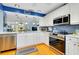 Bright kitchen featuring white cabinetry, stainless steel appliances, and modern backsplash at 838 Bird Bay Way # 114, Venice, FL 34285