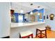 Cozy kitchen with stainless steel sink, granite countertops, and bar stool seating at 838 Bird Bay Way # 114, Venice, FL 34285