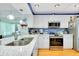 Modern kitchen with white cabinets, stainless steel appliances, and a bright backsplash at 838 Bird Bay Way # 114, Venice, FL 34285