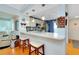 Bright kitchen featuring a bar with two stools and modern appliances at 838 Bird Bay Way # 114, Venice, FL 34285