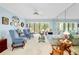 Bright living room featuring comfortable seating and natural light from the large window at 838 Bird Bay Way # 114, Venice, FL 34285