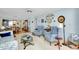 Open-concept living room and kitchen area with tile floors and ample natural light at 838 Bird Bay Way # 114, Venice, FL 34285