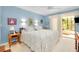 Comfortable main bedroom featuring a large bed and sliding glass doors to a patio at 838 Bird Bay Way # 114, Venice, FL 34285