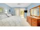 Comfortable main bedroom featuring a large bed and sliding glass doors to a patio at 838 Bird Bay Way # 114, Venice, FL 34285