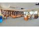 Bright community library with bookshelves lining the walls and tables for reading or studying at 838 Bird Bay Way # 114, Venice, FL 34285