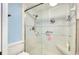 Bright, clean shower with glass doors and built-in bench and handrails at 838 Bird Bay Way # 114, Venice, FL 34285