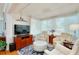 Sunroom featuring a TV, comfortable seating, and bright light at 838 Bird Bay Way # 114, Venice, FL 34285