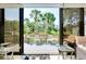 A sunroom looking onto an outdoor deck with furniture at 838 Bird Bay Way # 114, Venice, FL 34285