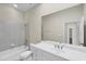 Bright bathroom featuring a white vanity, large mirror and shower-tub combo with tile surround at 9019 Eagle Bay Ct, North Port, FL 34287