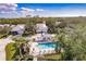 Aerial view of a home with a community pool surrounded by tropical greenery at 921 Tartan Dr # 31, Venice, FL 34293