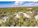 An aerial view of a property enveloped by trees with a peek at the community pool at 921 Tartan Dr # 31, Venice, FL 34293