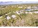 High aerial view of community with extensive foliage, and the nearby lake at 921 Tartan Dr # 31, Venice, FL 34293