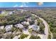 Aerial view of a community with a nearby golf course and lake at 921 Tartan Dr # 31, Venice, FL 34293