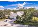 Beautiful aerial view of a well-maintained home with lush landscaping, three-car garage, and serene surroundings at 921 Tartan Dr # 31, Venice, FL 34293