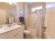 Well-lit bathroom features a white vanity, framed mirror, shower-tub combo, and decorative shower curtain at 921 Tartan Dr # 31, Venice, FL 34293