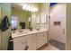 Modern bathroom featuring double sinks, sleek vanity, and a glass-enclosed shower with stylish tile accents at 921 Tartan Dr # 31, Venice, FL 34293