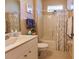Bright bathroom featuring a tile floor, a shower-tub combo with curtain, and white vanity and sink at 921 Tartan Dr # 31, Venice, FL 34293