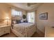 Cozy bedroom with ceiling fan, windows with curtains, and a queen-sized bed with decorative pillows at 921 Tartan Dr # 31, Venice, FL 34293