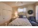 Bedroom boasts a queen-sized bed, ceiling fan, neutral walls, windows, and a comfortable chair at 921 Tartan Dr # 31, Venice, FL 34293