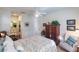 Bright bedroom with a floral queen bed, ceiling fan, walk-in closet, and adjoining bathroom at 921 Tartan Dr # 31, Venice, FL 34293