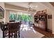Bright dining area featuring a ceiling fan and sliding glass doors leading to a patio and lush backyard at 921 Tartan Dr # 31, Venice, FL 34293