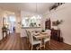 Dining room with elegant chandelier, wood floors, and views of the kitchen area through a wide opening at 921 Tartan Dr # 31, Venice, FL 34293