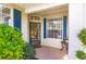 Welcoming front porch with blue shutters and charming decor offers a delightful entrance at 921 Tartan Dr # 31, Venice, FL 34293