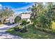 The house has beautiful landscaping and a well-manicured front yard with a welcoming appeal at 921 Tartan Dr # 31, Venice, FL 34293
