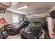 Well-lit garage with two cars, overhead door, window, wall decorations and storage shelves at 921 Tartan Dr # 31, Venice, FL 34293