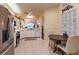 Bright kitchen with stainless steel appliances, white cabinets, and breakfast nook, perfect for Gathering meals at 921 Tartan Dr # 31, Venice, FL 34293
