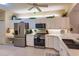 Well-lit kitchen with stainless steel appliances, white cabinetry, and an eat-in counter space at 921 Tartan Dr # 31, Venice, FL 34293