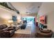 Bright living room with hardwood floors and view to screened in patio at 921 Tartan Dr # 31, Venice, FL 34293