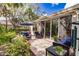 Inviting outdoor patio with comfortable seating and lush tropical landscaping at 921 Tartan Dr # 31, Venice, FL 34293